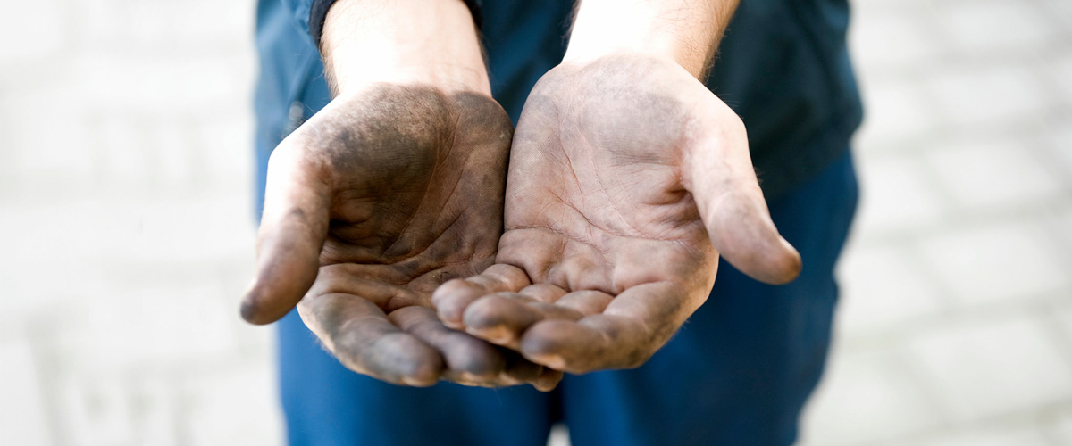 A pair of hands that are dirty from working